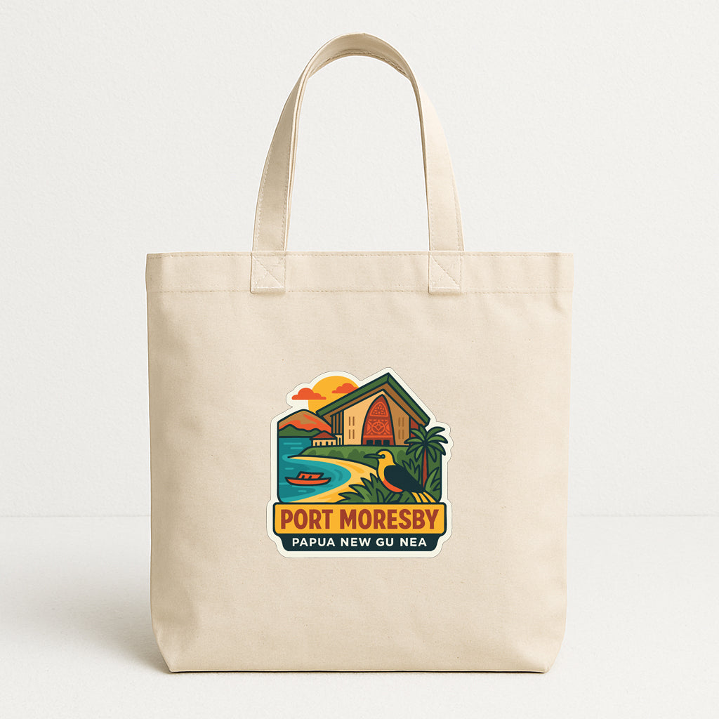 A beige tote bag with a graphic design depicting a tropical beach scene, including a house, palm trees, and a sunset.