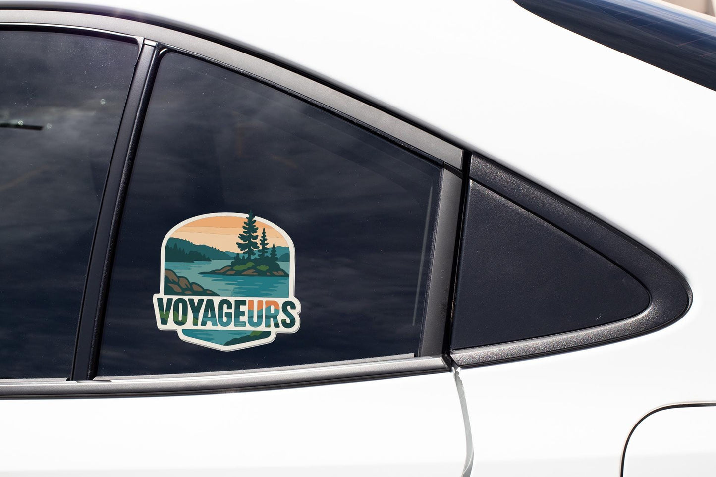 A sticker on the side of a car window that says "VOYAGEURS".