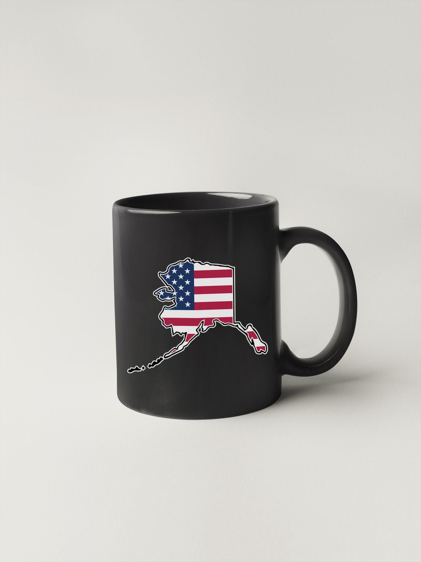 a black coffee mug with the american flag on it