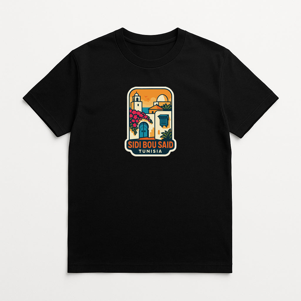 A black t-shirt with a colorful graphic design depicting a building and a palm tree, along with the text "SIDI BOU SAID TUNISIA" printed on it.