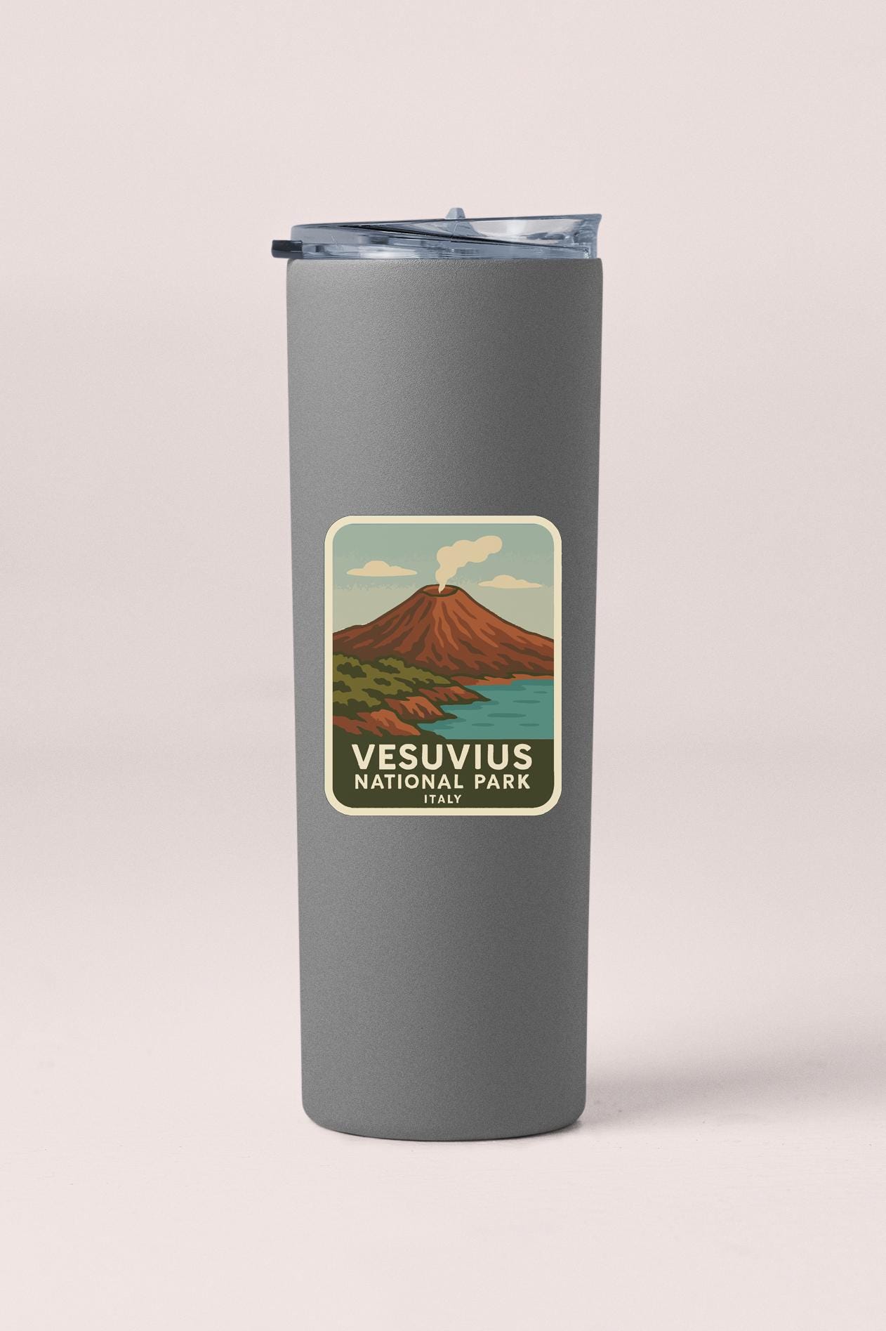 A gray insulated tumbler with a label that features an illustration of Vesuvius, the famous volcano in Italy.