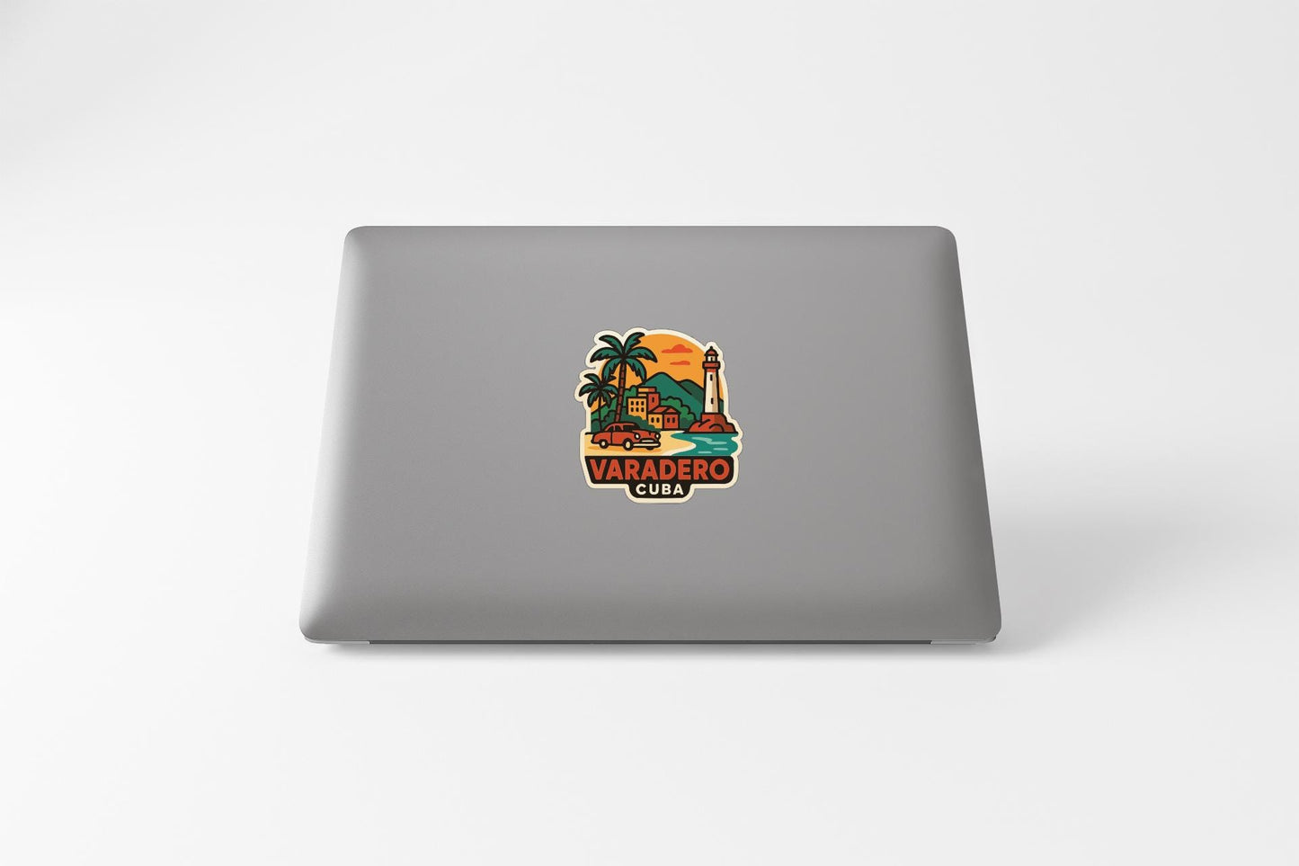 a sticker with a tropical scene and the text "VARADERO CUBA" on a grey laptop.