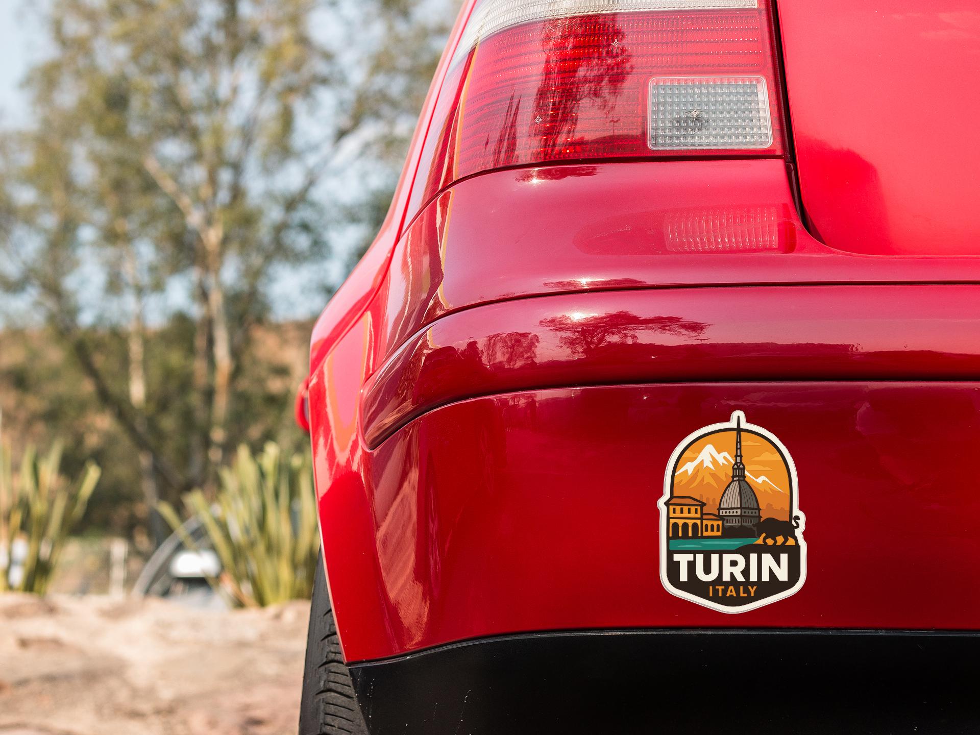 the rear end of a red car with a sticker on the trunk that says "TURIN ITALY".