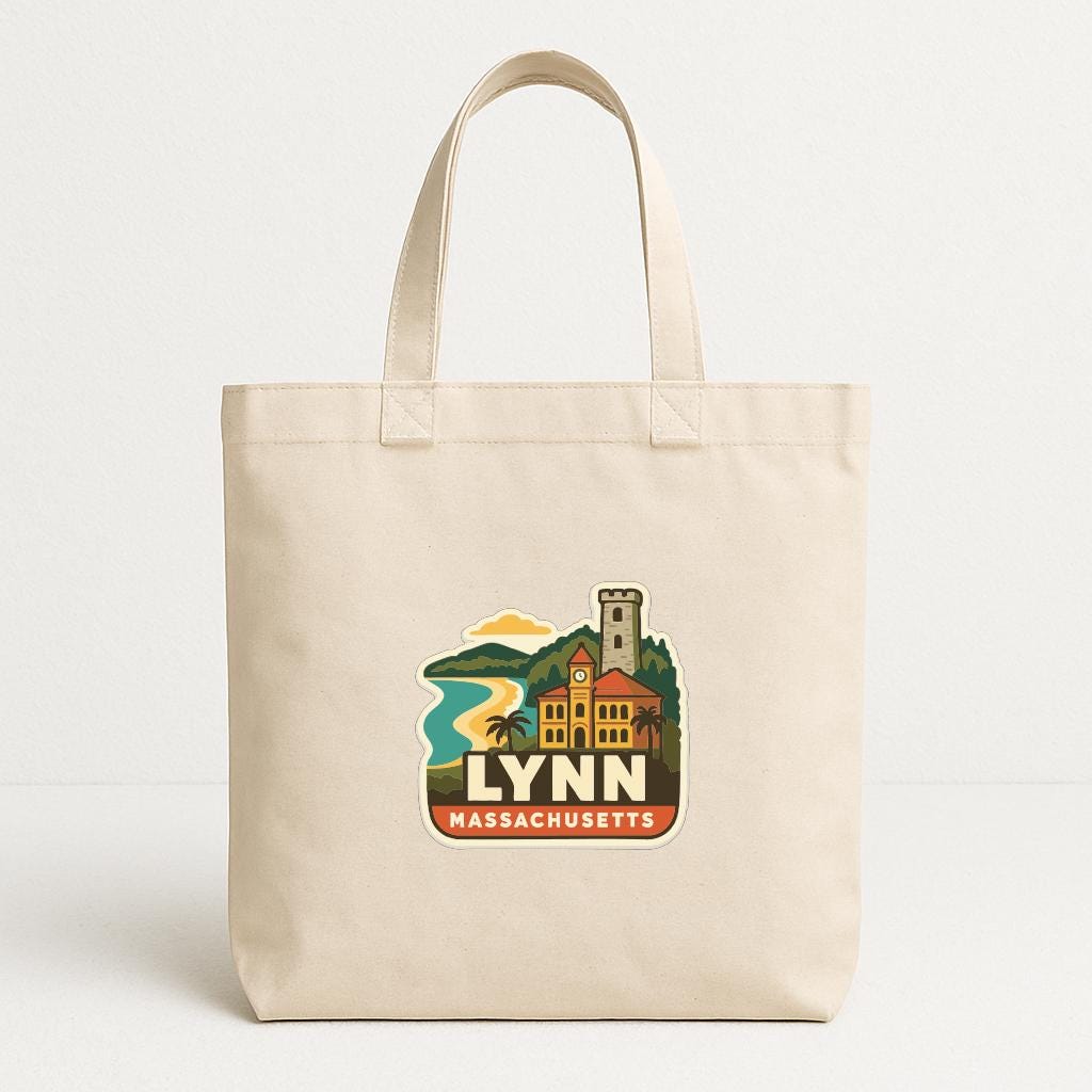 A beige tote bag with a graphic design depicting a town or city, featuring a clock tower, buildings, and a body of water.