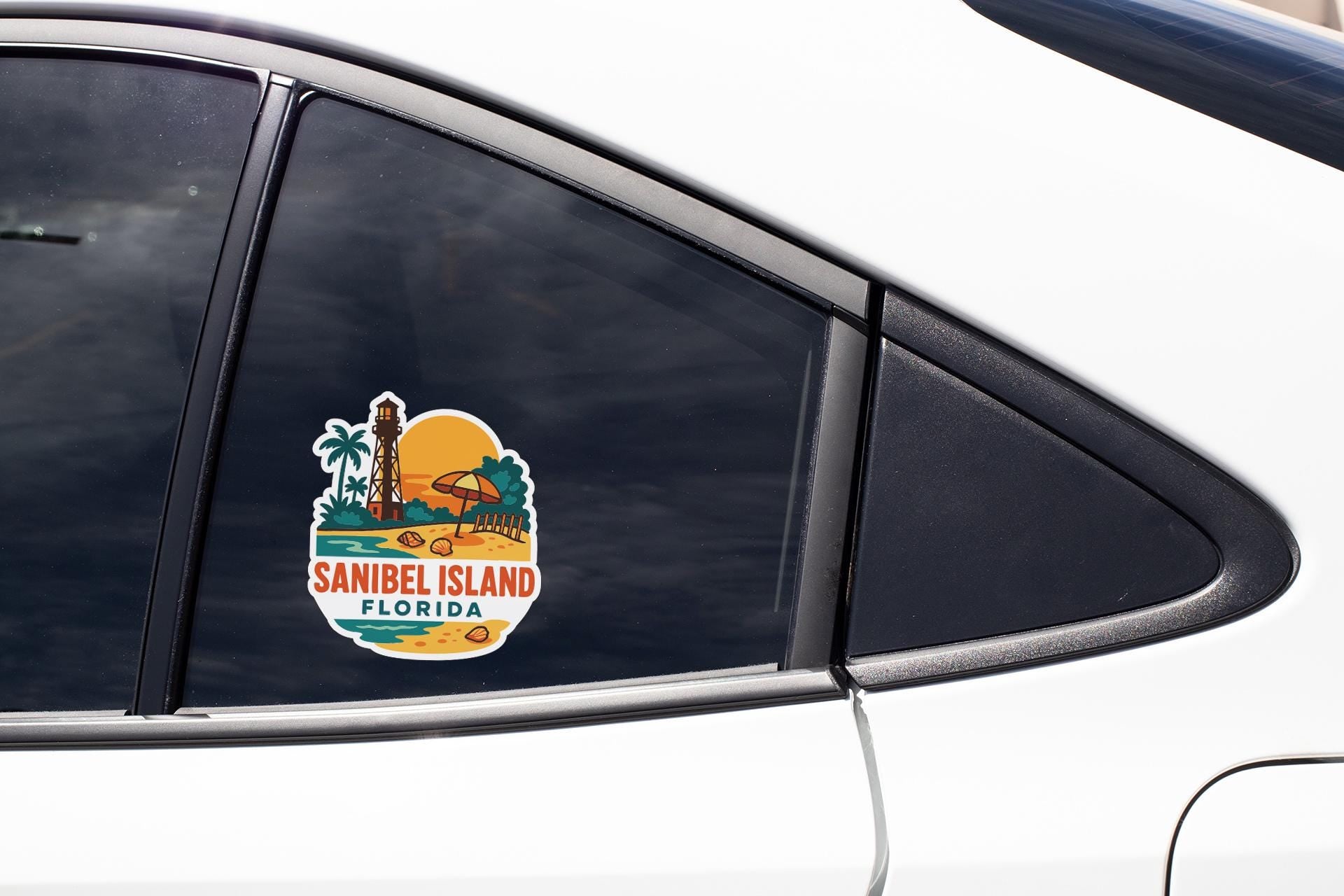 A sticker on the side of a car window, depicting a tropical beach scene with palm trees and a lighthouse, along with the text "SANIBEL ISLAND FLORIDA".