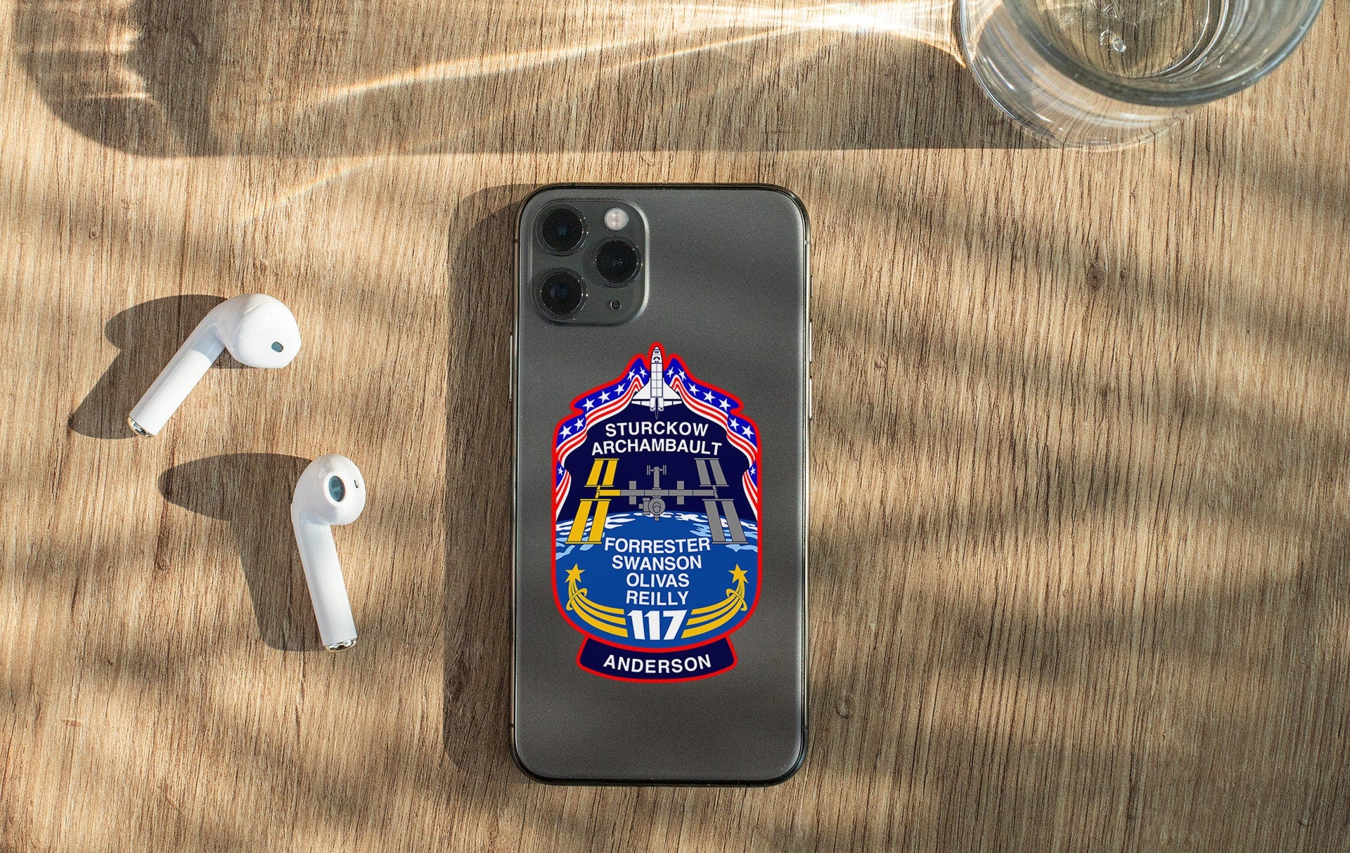 a cell phone and ear buds sitting on a table