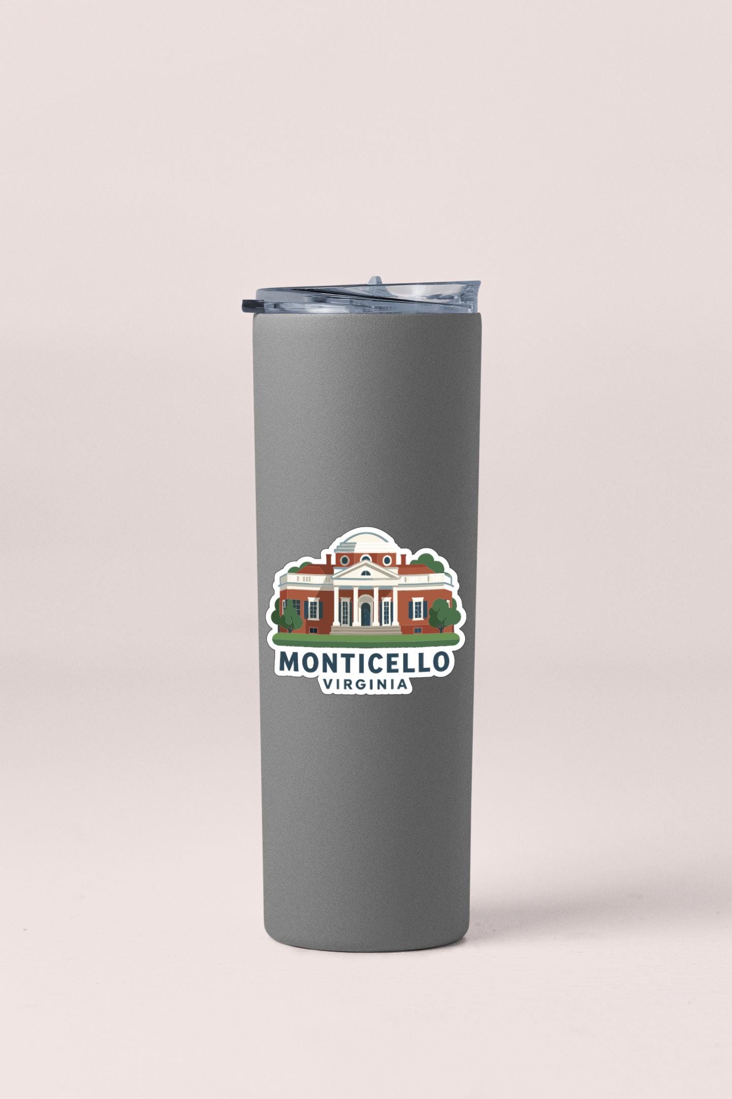 A gray insulated tumbler with a printed label that says "MONTICELLO VIRGINIA".