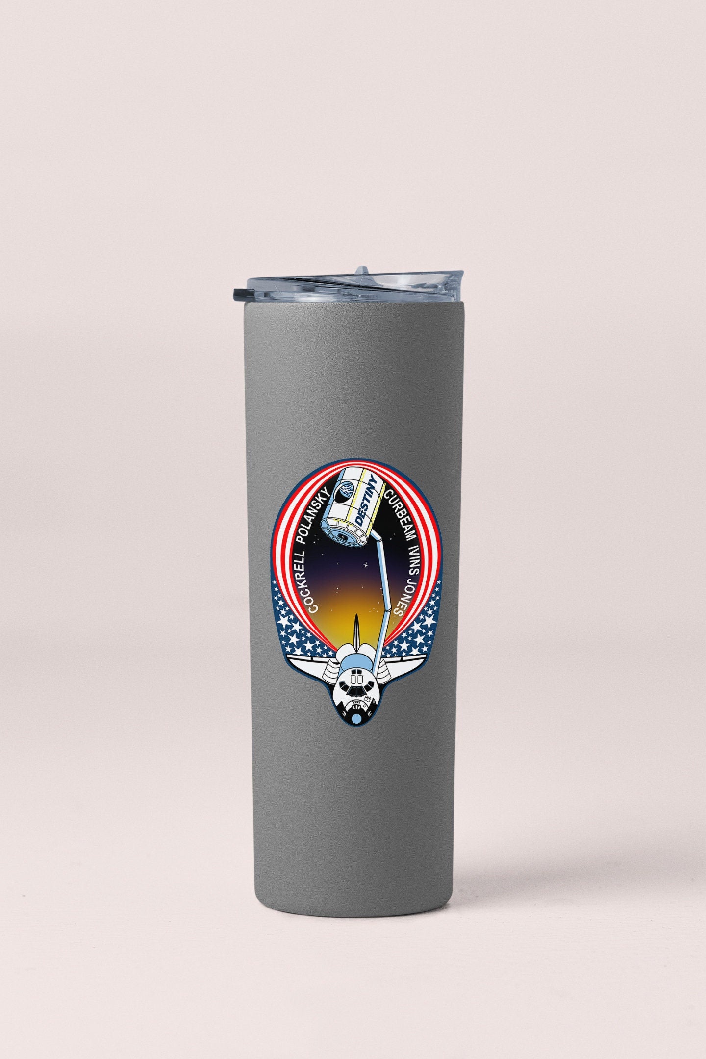a tumbler cup with a picture of a space shuttle on it