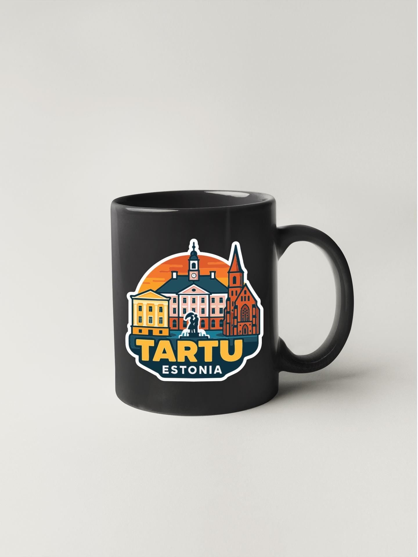 A black coffee mug with a colorful graphic design depicting the city of Tartu, Estonia.