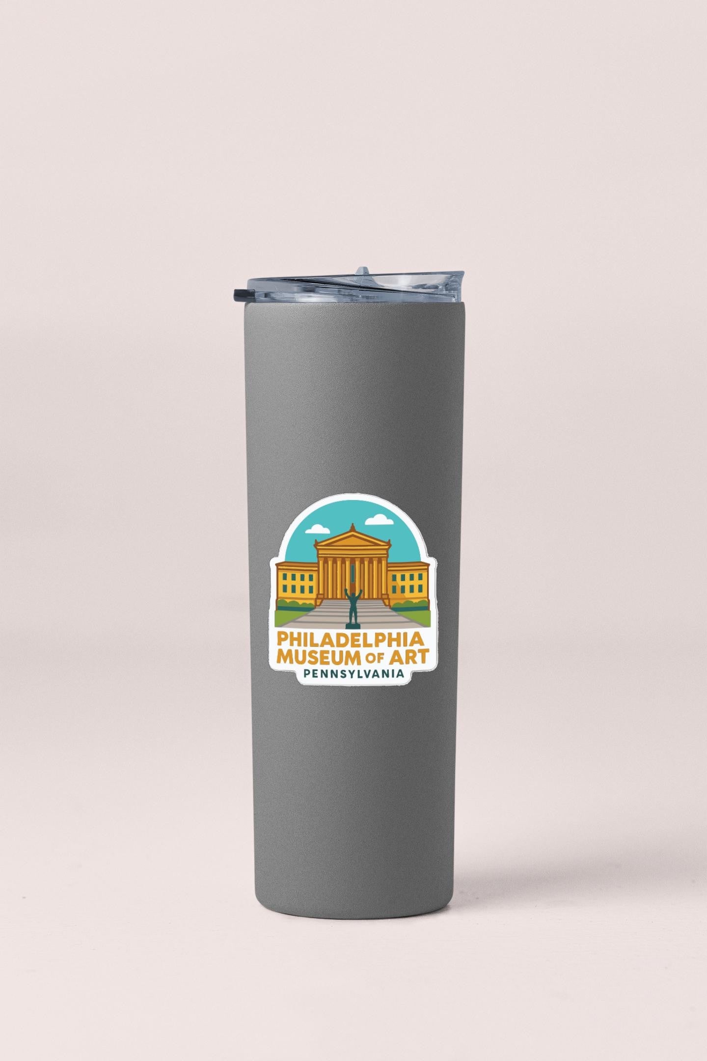 A gray insulated tumbler with a Philadelphia Museum of Art sticker printed on it.
