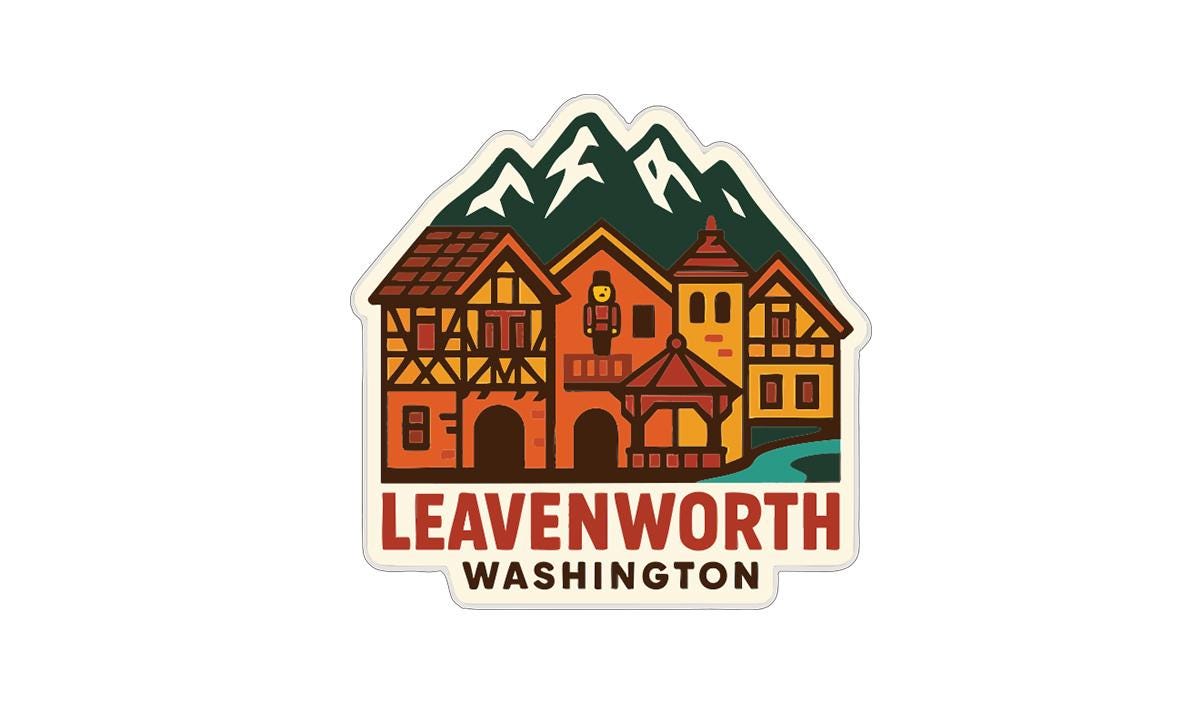 a sticker or logo depicting a village with traditional half-timbered houses, mountains in the background, and the text "LEAVENWORTH WASHINGTON" prominently displayed.
