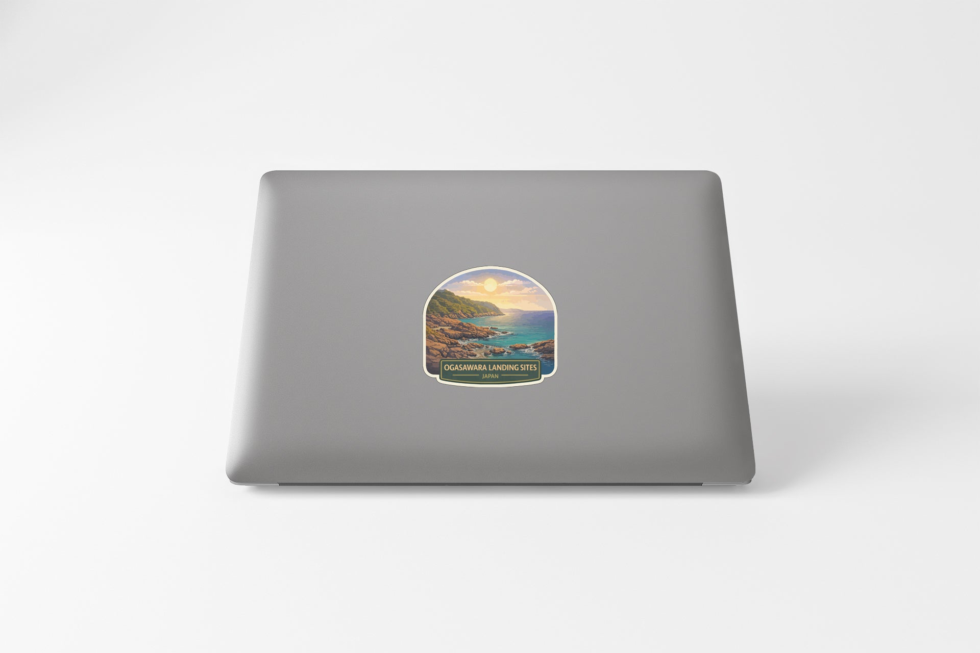 A sticker depicting a scenic coastal landscape with mountains and a body of water.