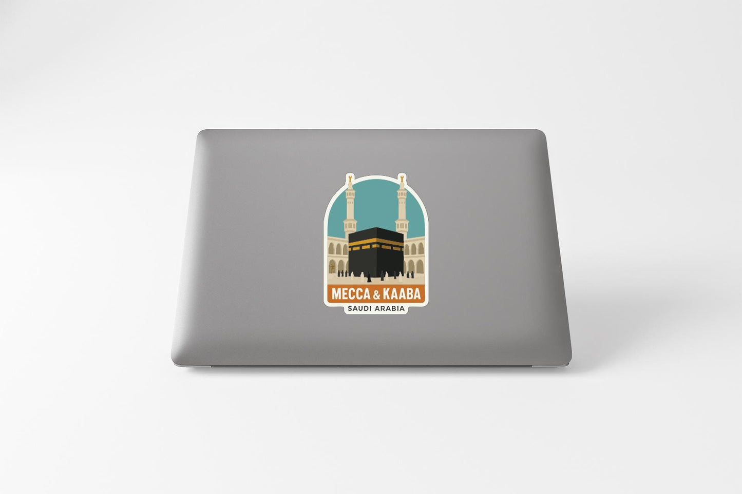 a sticker or decal on the back of a laptop, depicting a mosque with two minarets and a black building in the center.
