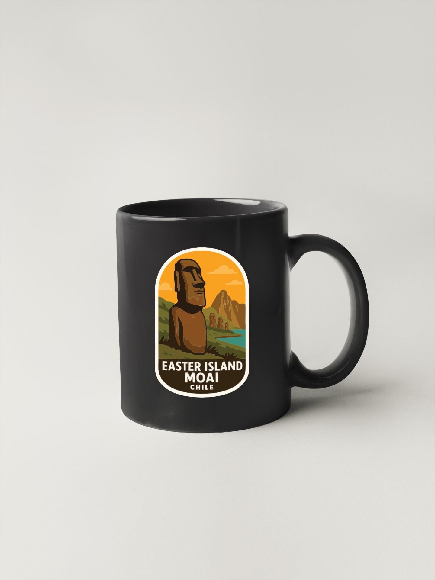 A black coffee mug with a label that says "EASTER ISLAND MOAIO CHILE" featuring an illustration of Easter Island.