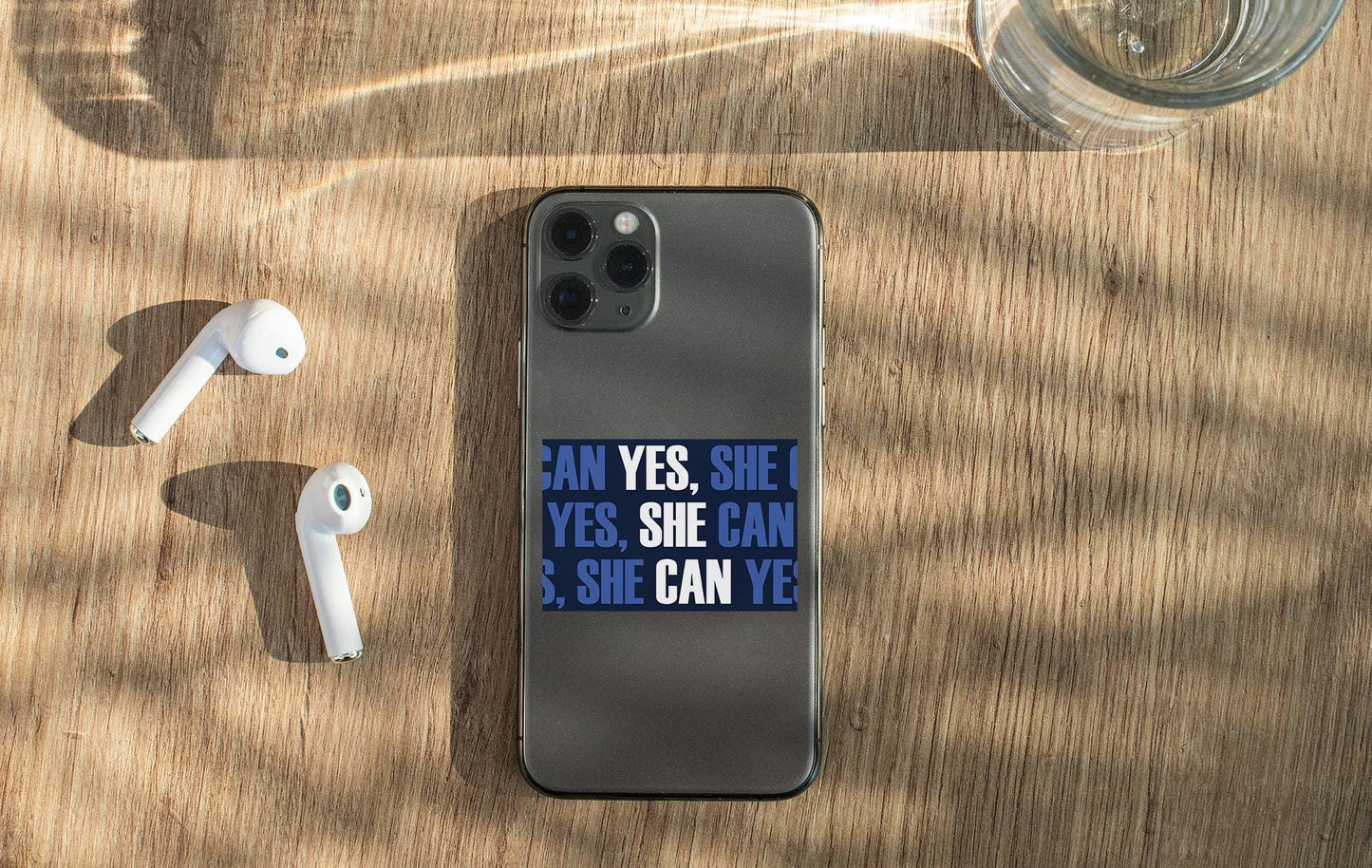 an iphone and ear buds sitting on a table