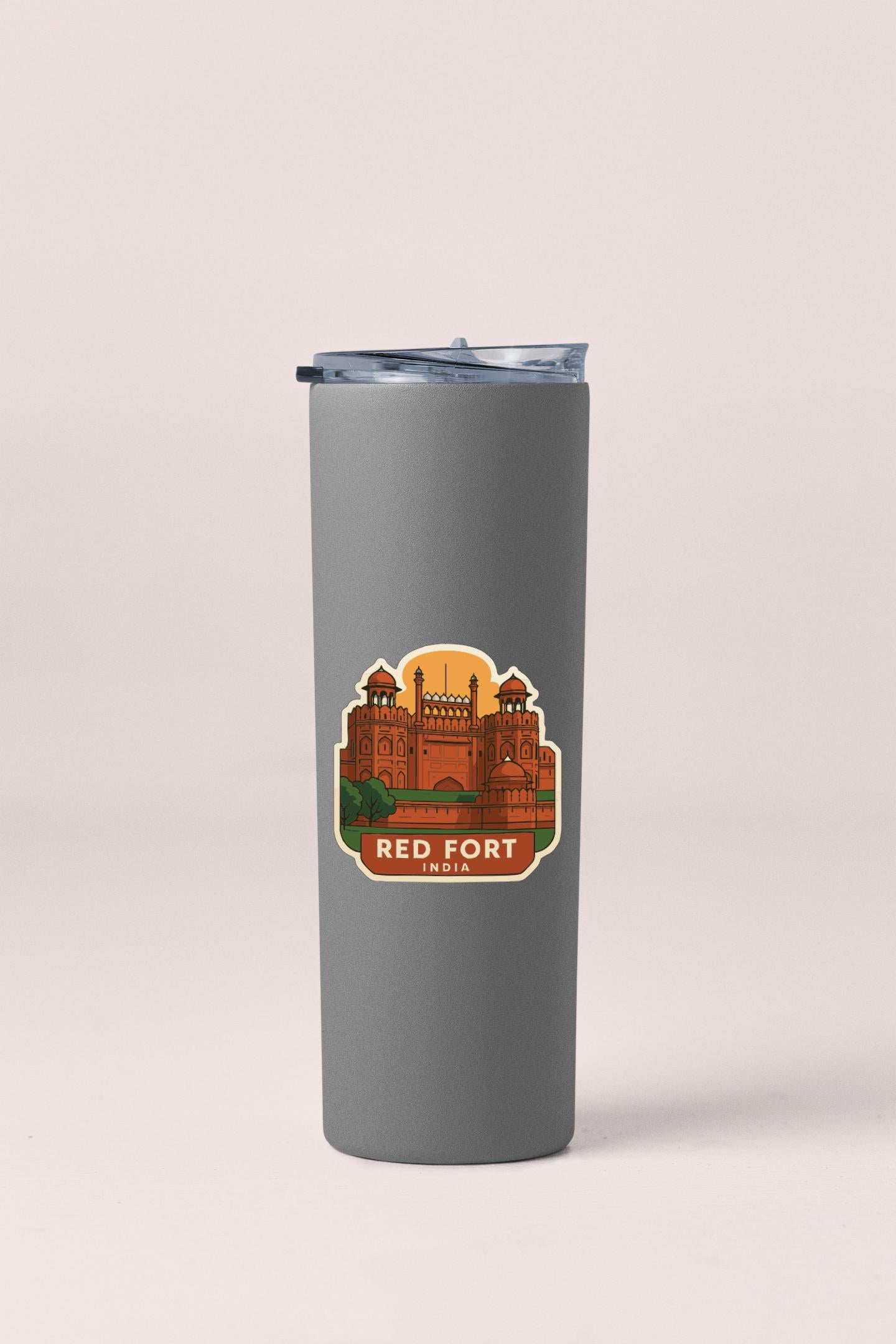 A gray insulated tumbler with a sticker depicting the Red Fort in India.