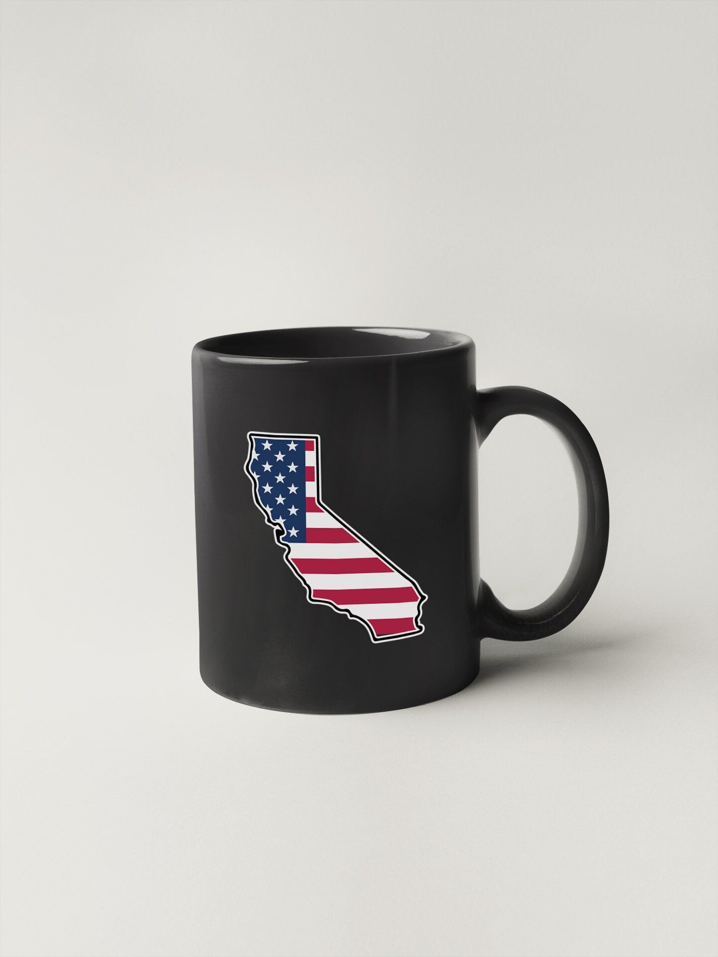 a black coffee mug with the state of california painted on it