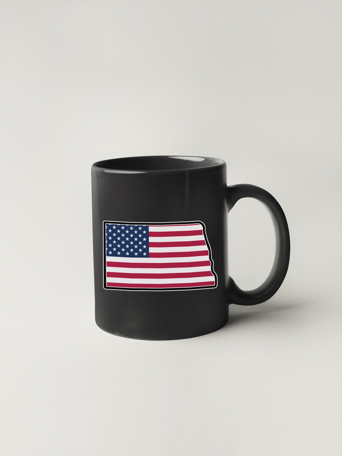 a black mug with the state of indiana painted on it