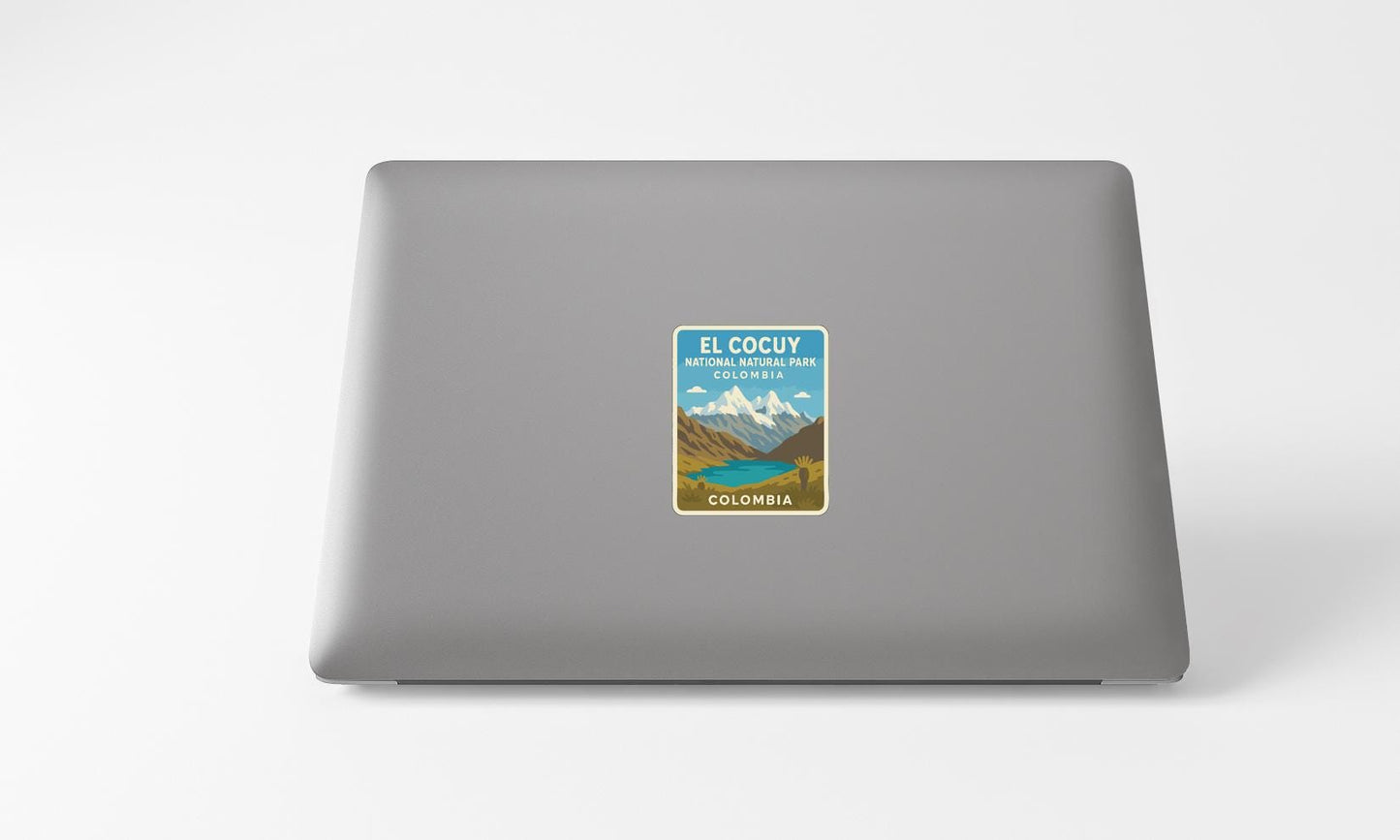 A sticker on the back of a laptop, depicting a scenic mountain landscape with a lake and mountains in the background.