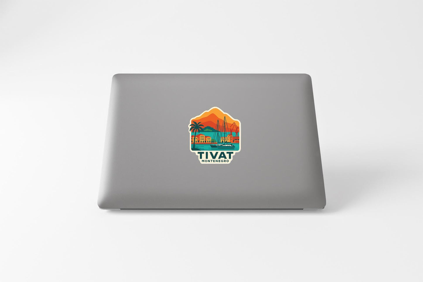 a sticker on the back of a laptop with a colorful illustration of a tropical landscape.