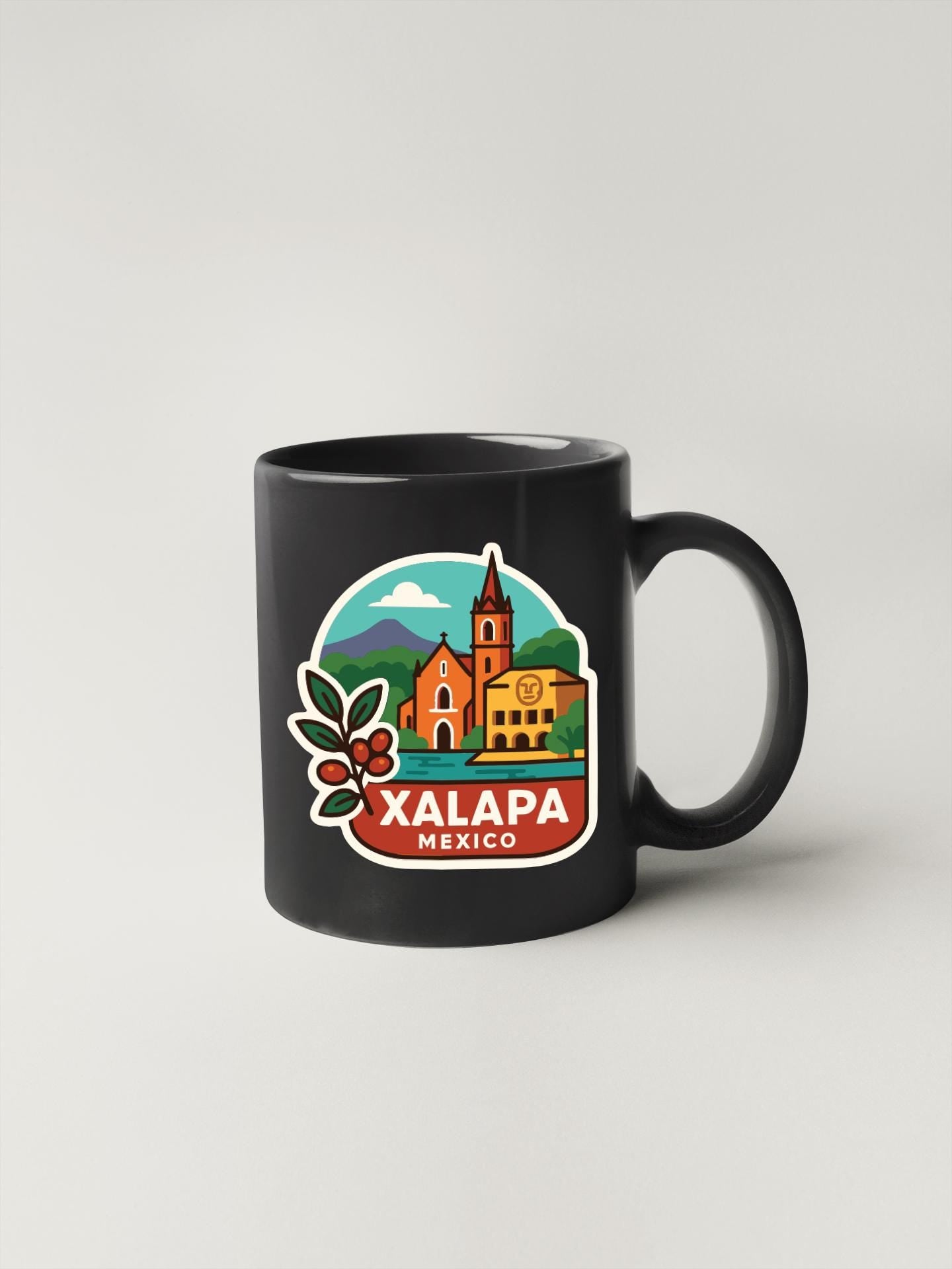 A black coffee mug with a colorful illustration of a cityscape and the text "XALAPA MEXICO" printed on it.