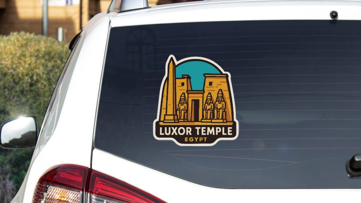 A sticker on the rear window of a car that features an illustration of Luxor Temple in Egypt.