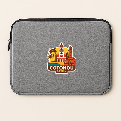 a gray laptop sleeve with a sticker of the city of Cotonou, Benin.