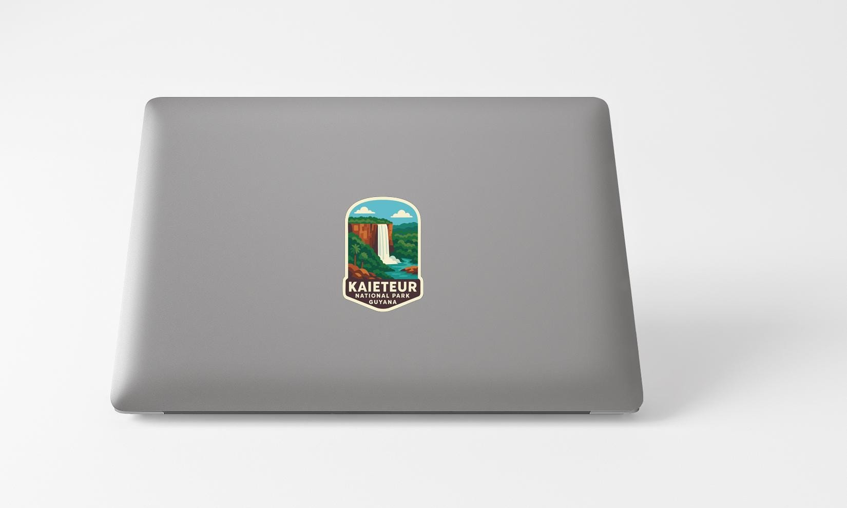 A sticker on the back of a laptop, depicting a waterfall and the text "KAIETEUR KAYATAI".