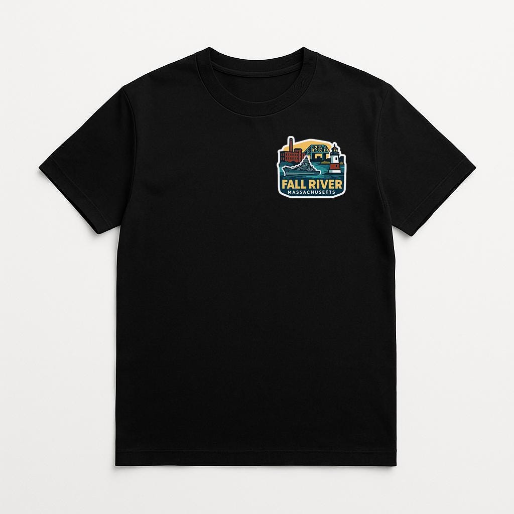 A black t-shirt with a colorful graphic on the front, depicting a cityscape with a river and a lighthouse.