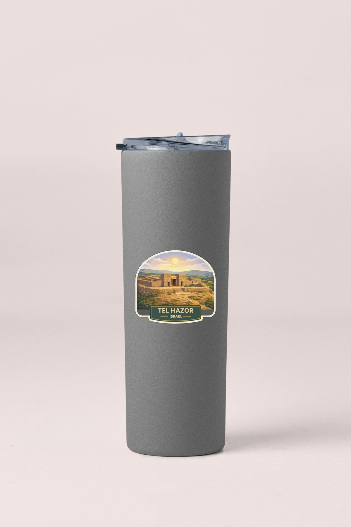 A gray cylindrical container with a label that features an image of the Tel HaZor, a historic site in Israel.