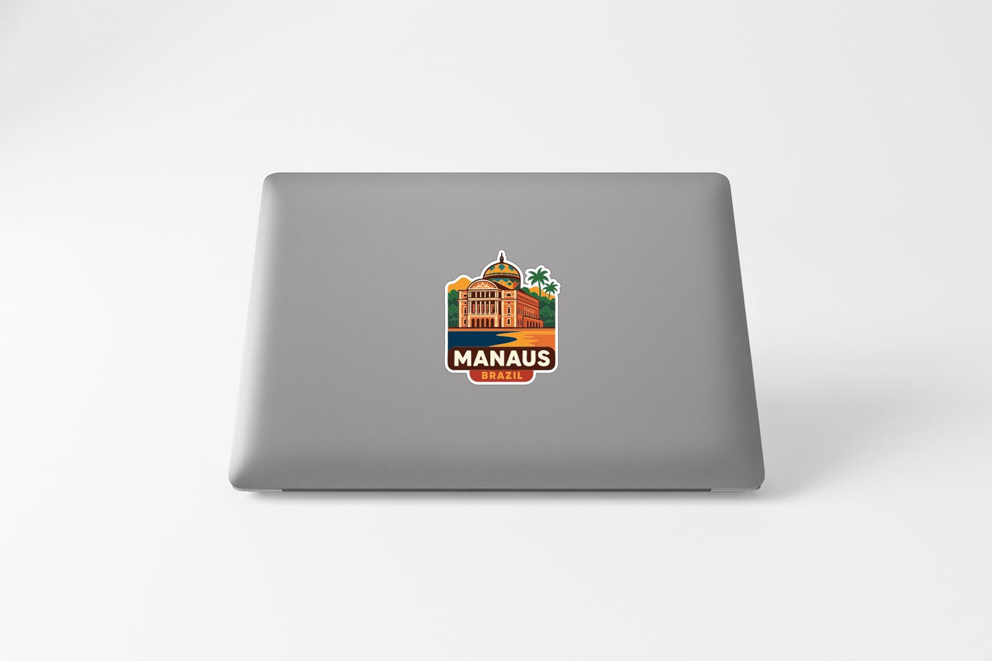 a sticker with a building and palm trees on a laptop.