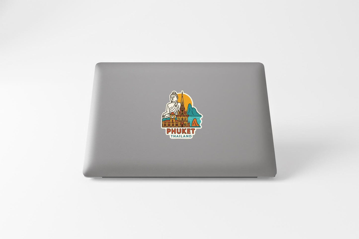 a sticker on the back of a laptop that says "PHUKET THAILAND".