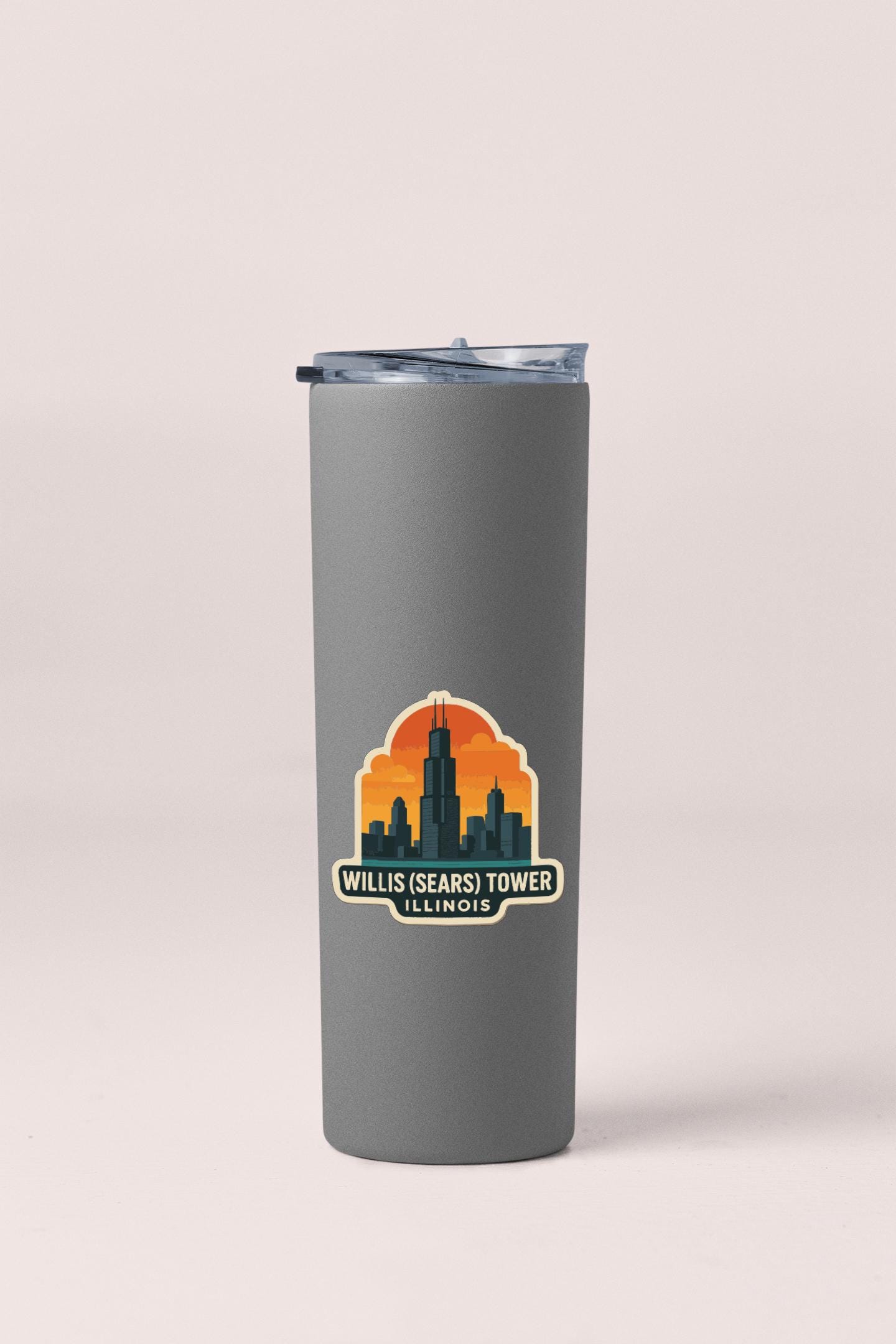 A gray insulated tumbler with a sticker depicting the Willis Tower ( Willis Tower ) in Chicago, Illinois.
