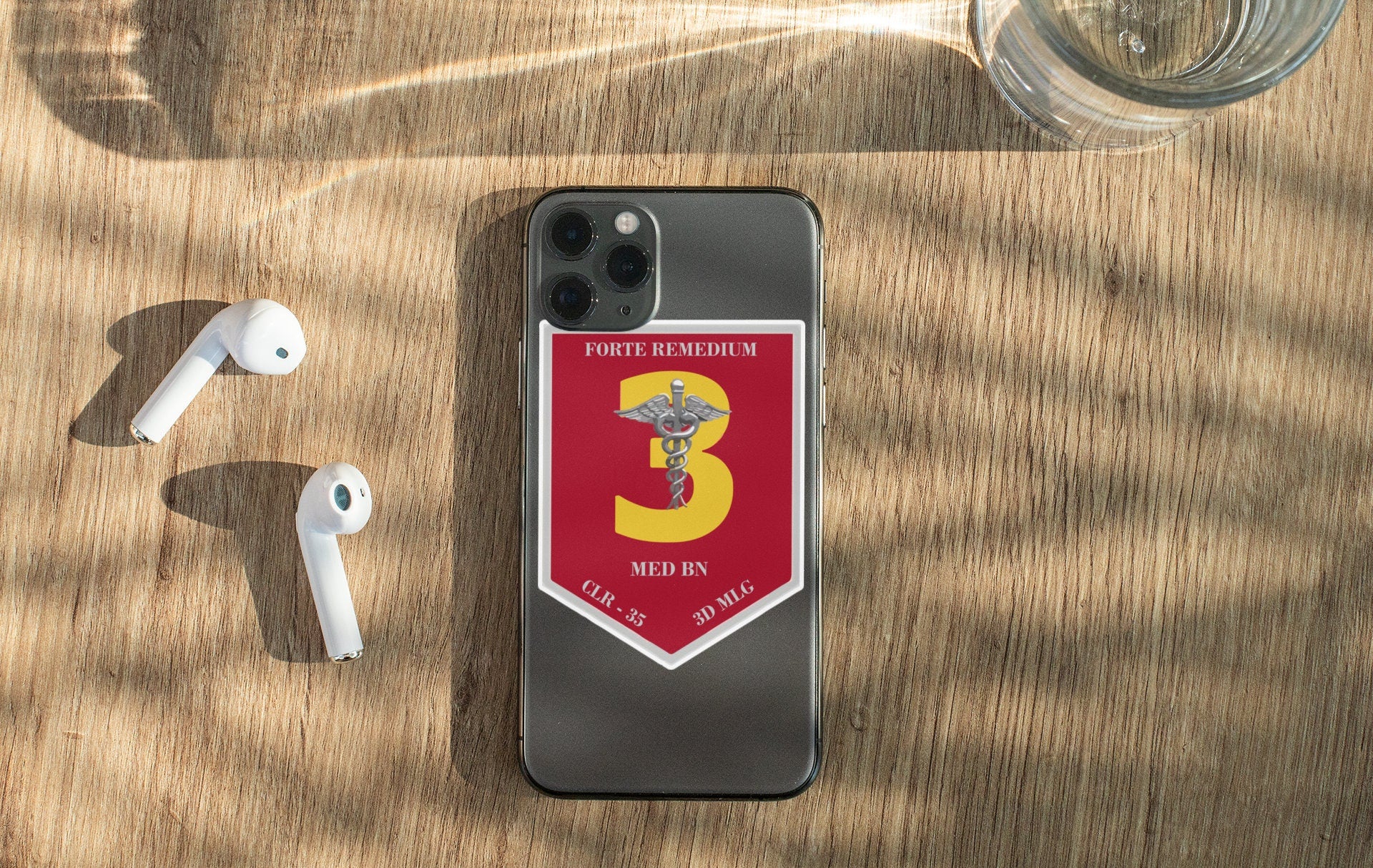 a phone with a red and yellow 3 medal on it