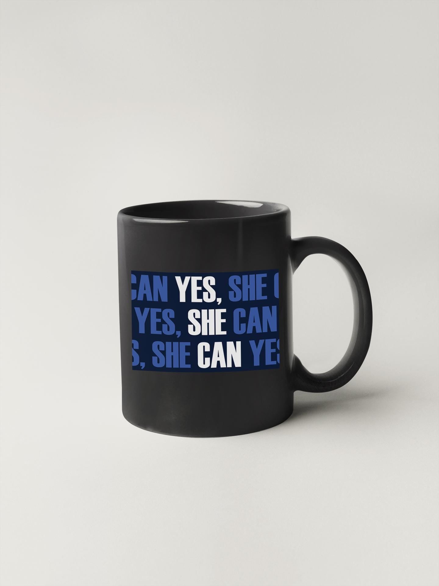 a black coffee mug with blue writing on it