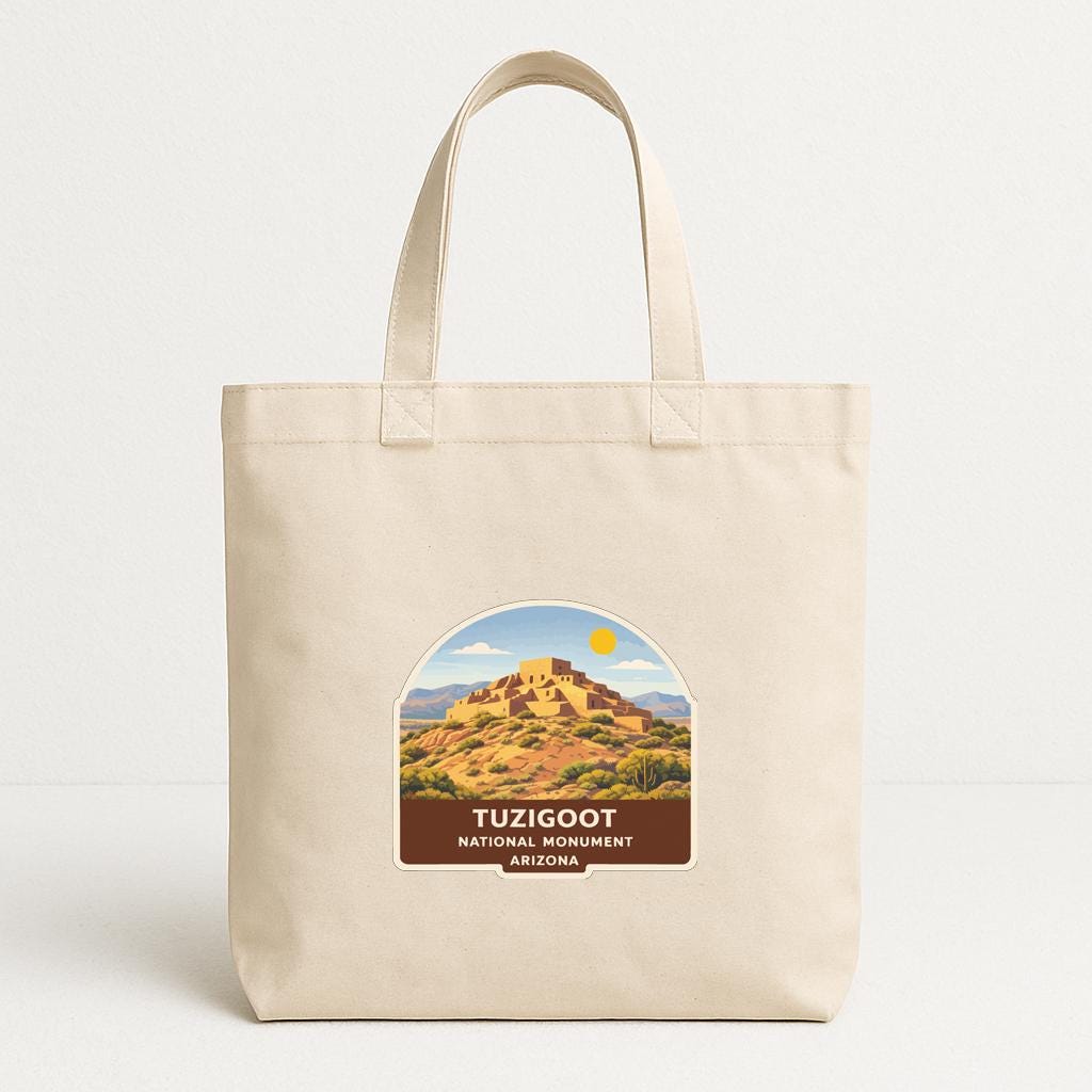 A beige tote bag with a label that features an illustration of the Tucigot National Monument in Arizona.
