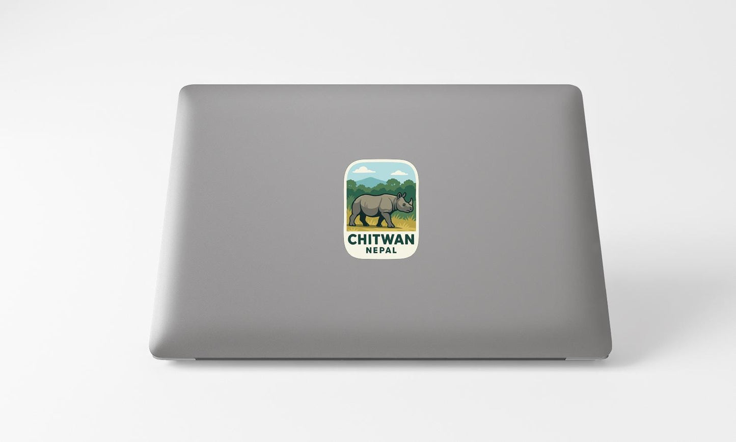 a sticker with a rhinoceros and the text "CHITWAN NEPAIL" on the back of a laptop.