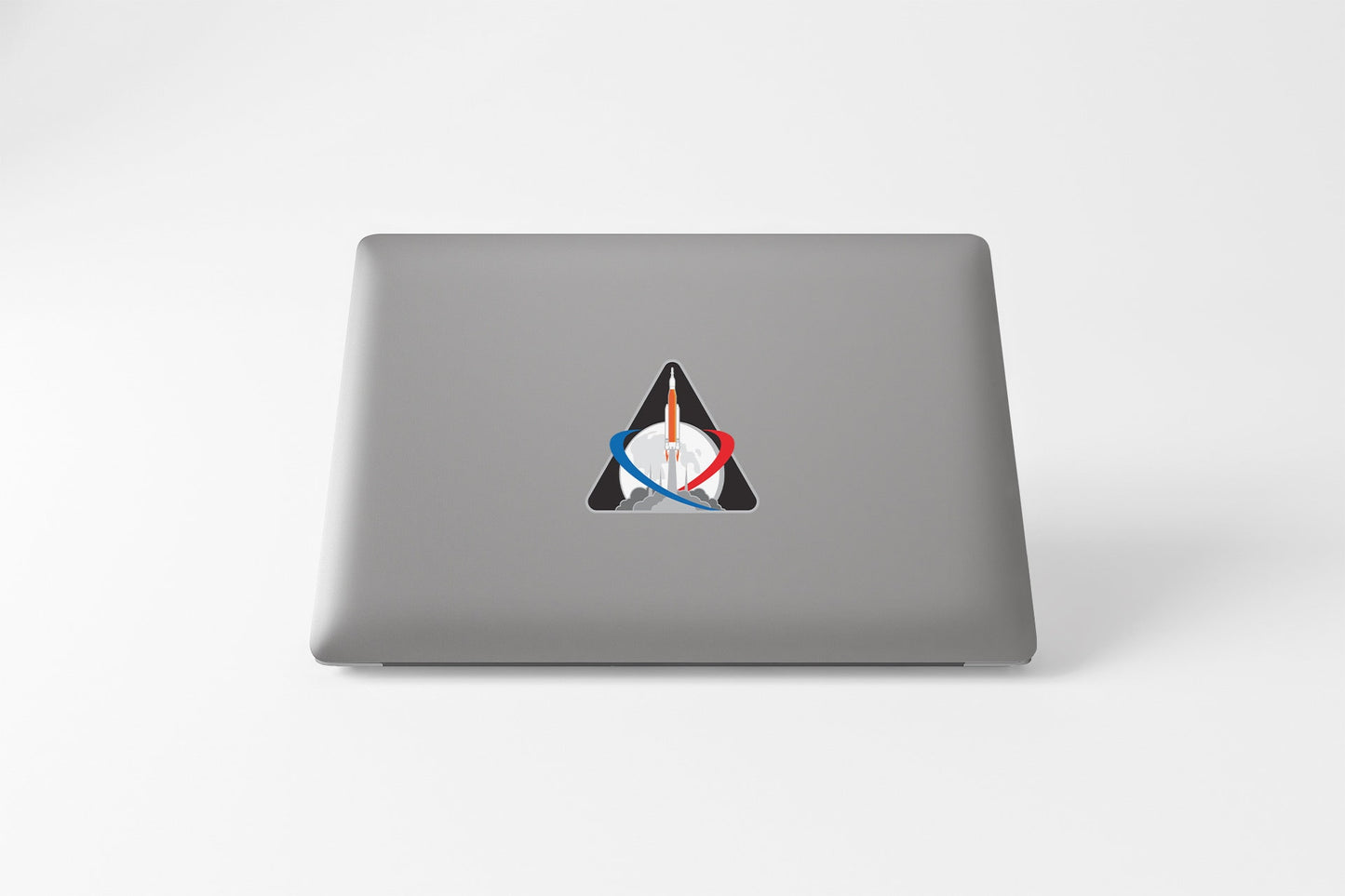 a laptop with a sticker of a triangle on it