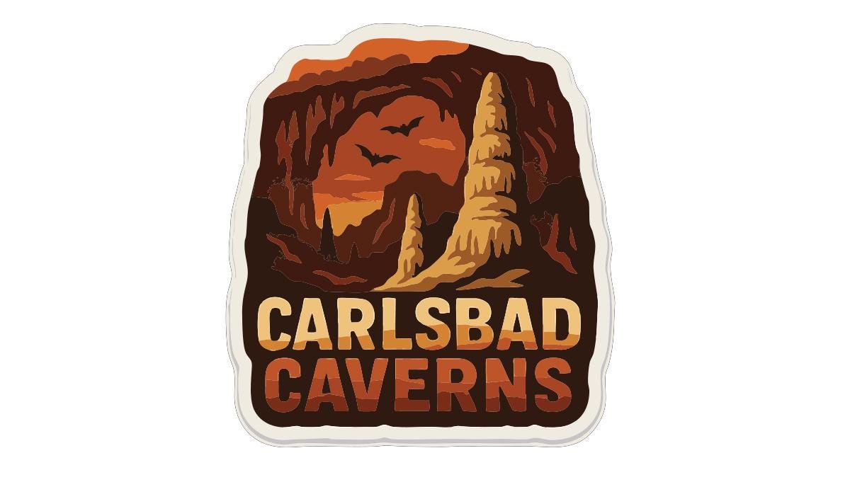 A sticker or label with the text "CARLSBAD CAVENS" and an illustration of a cave with bats flying around it.