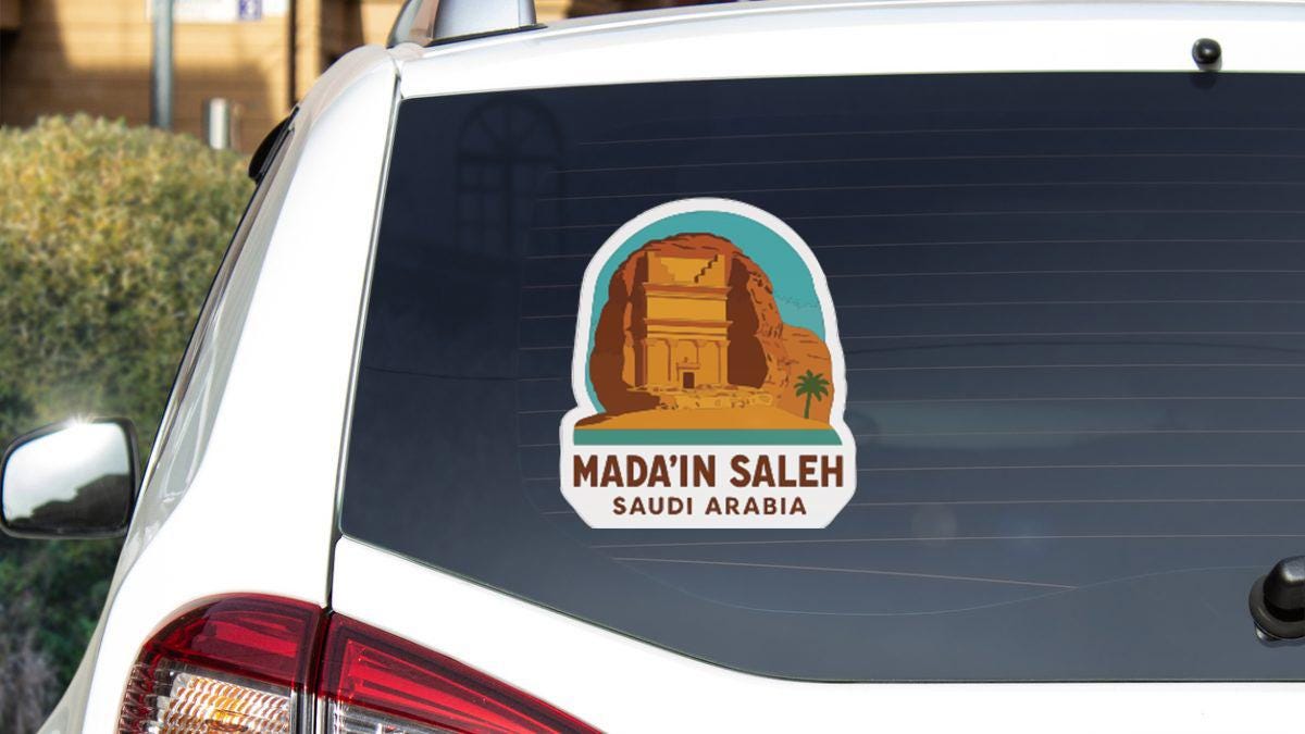 A sticker on the rear window of a car that says "MADINA SALEH SAUDI ARABIA".