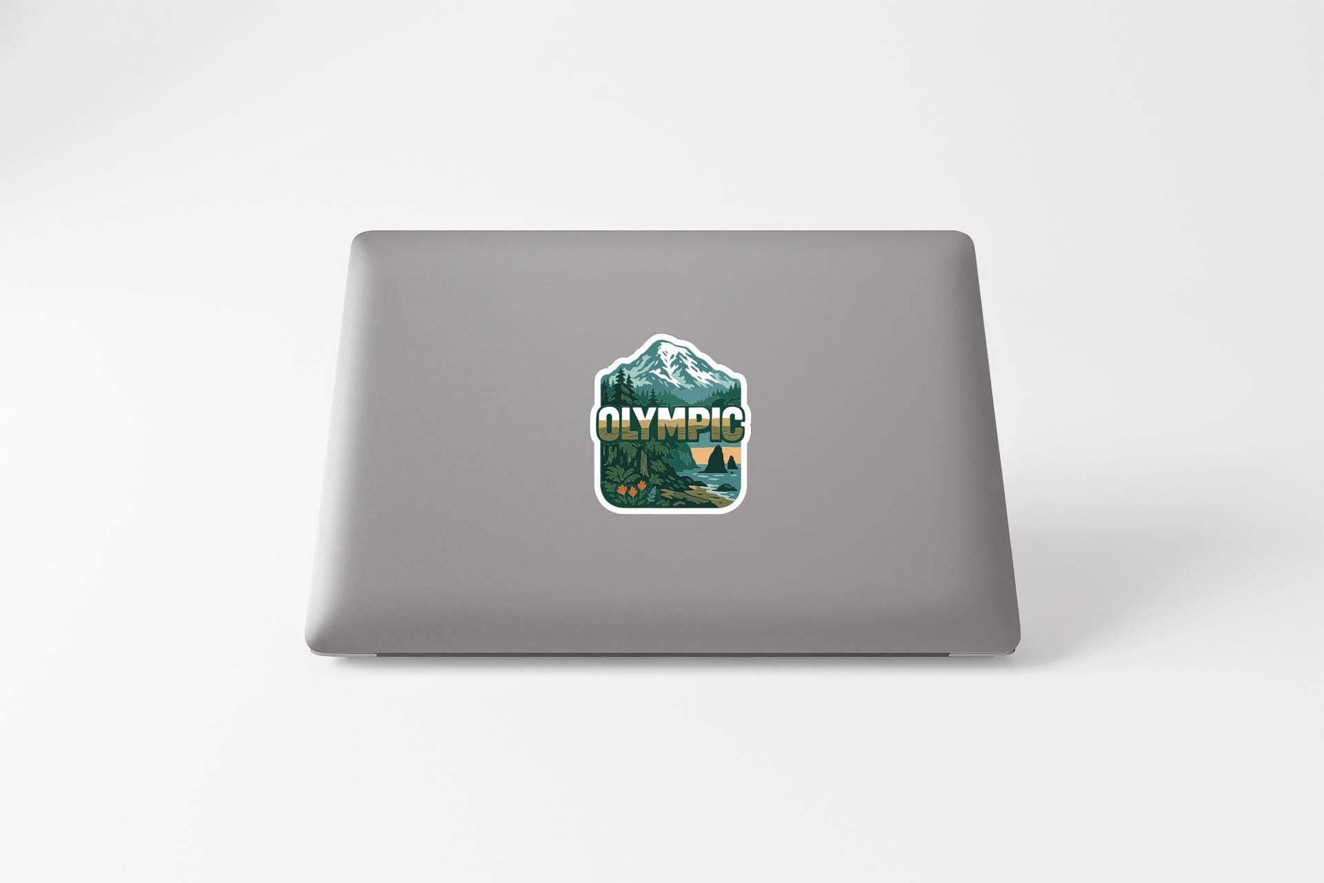 A sticker on the back of a laptop displaying the word "OLYMPIA" and a mountain landscape.