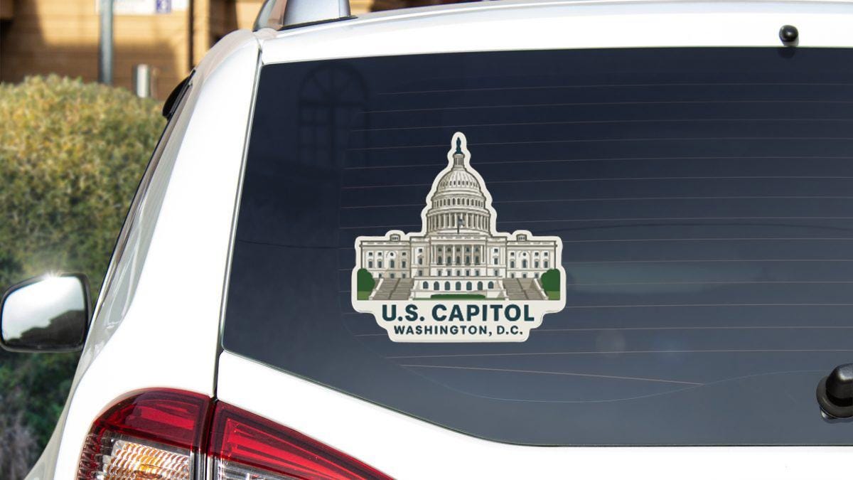 A sticker on the rear window of a car that features the U.S. Capitol building in Washington, D.C.