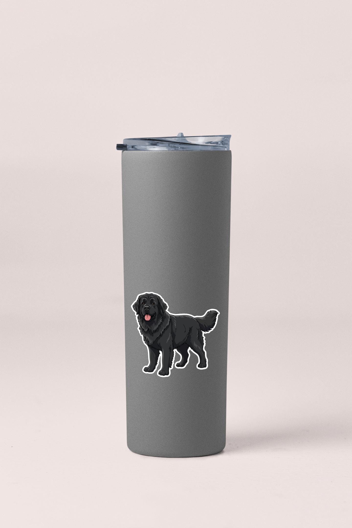 A gray tumbler with a sticker of a black dog on it.