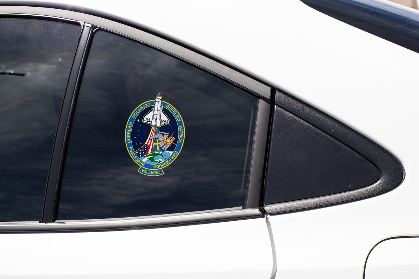 a close up of a car mirror with a space shuttle emblem on it