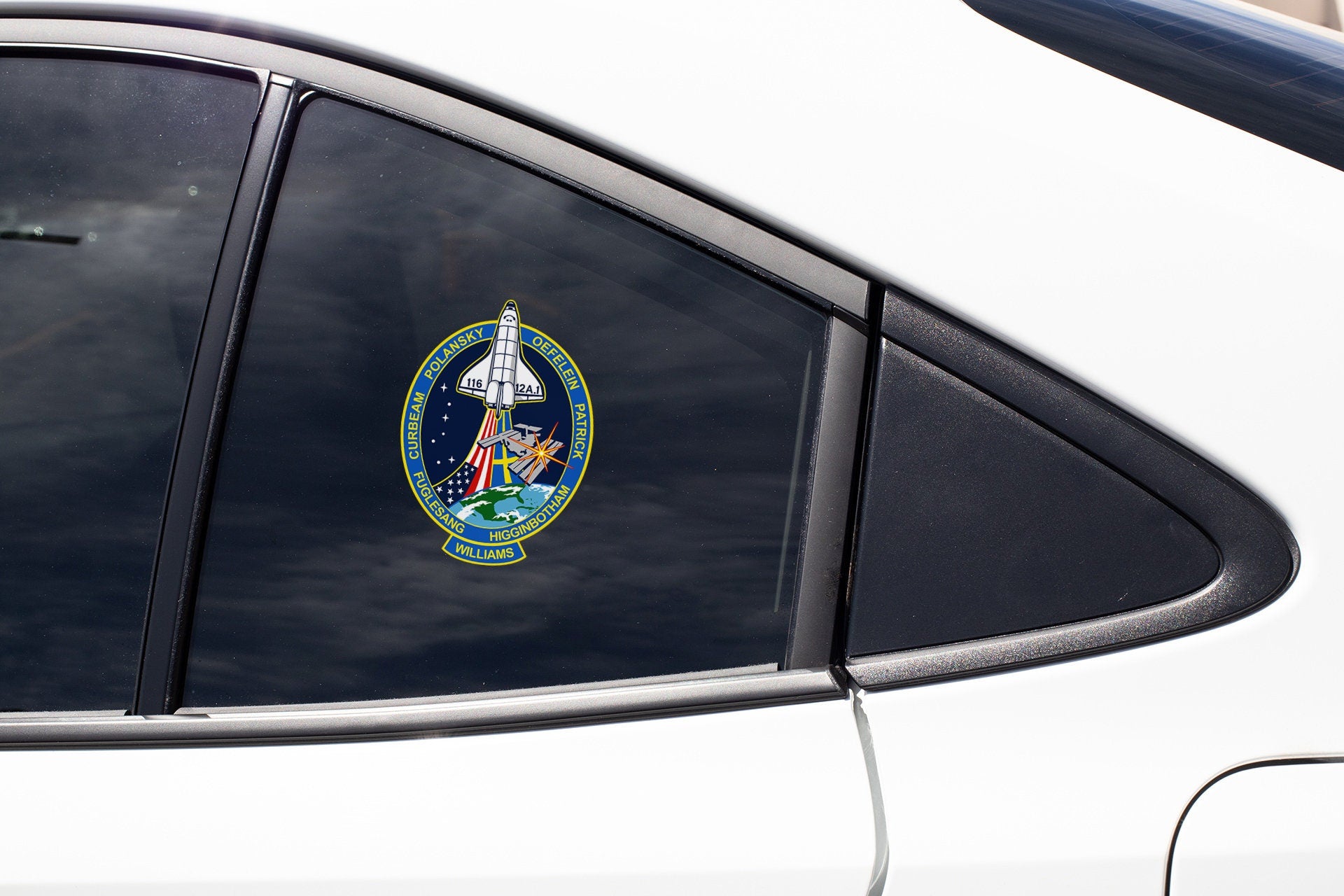 a close up of a car mirror with a space shuttle emblem on it