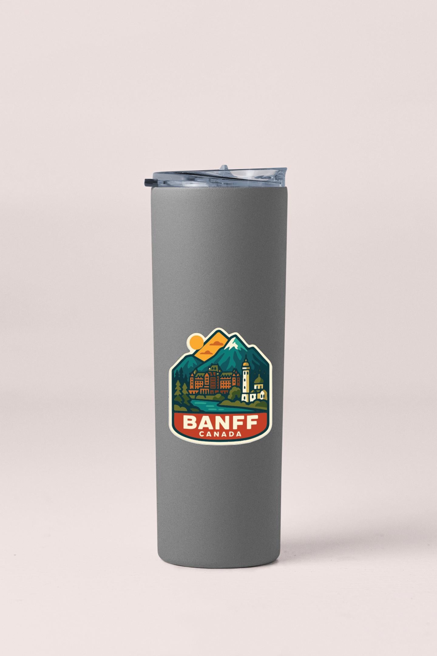 A gray insulated tumbler with a lid and a label that says "Banff, Canada".