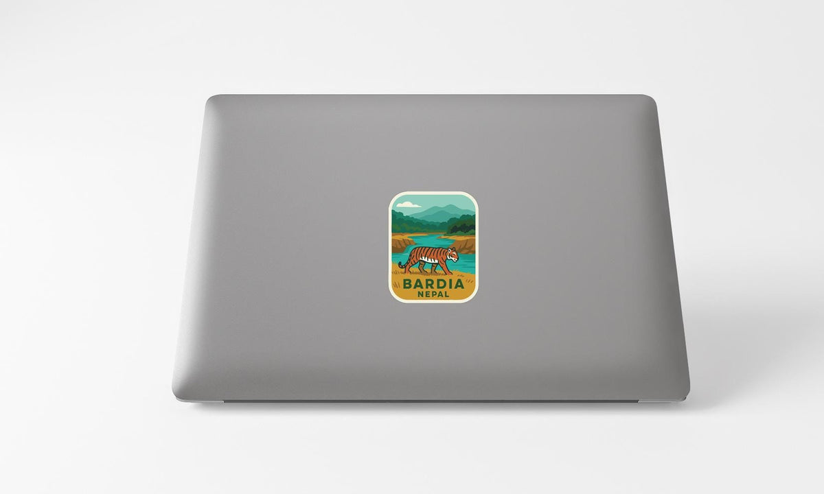 A sticker on the back of a laptop displaying a tiger in a natural setting.