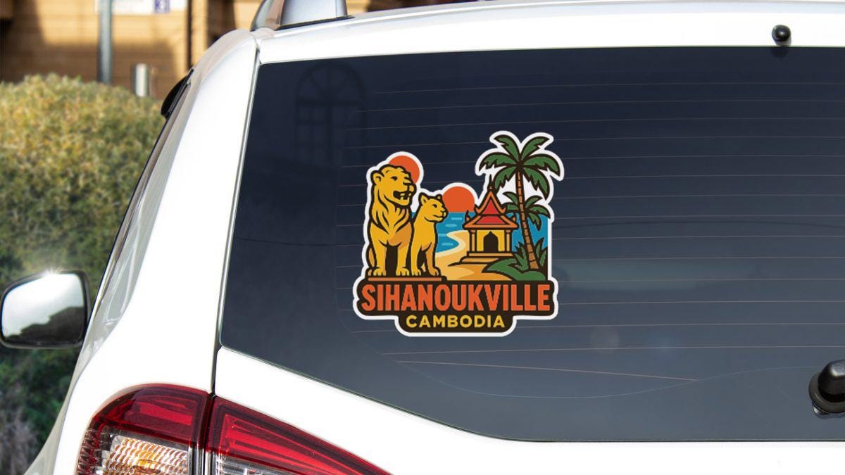 A sticker on the rear window of a white vehicle, depicting a tropical scene with a lion, palm tree, and a building.