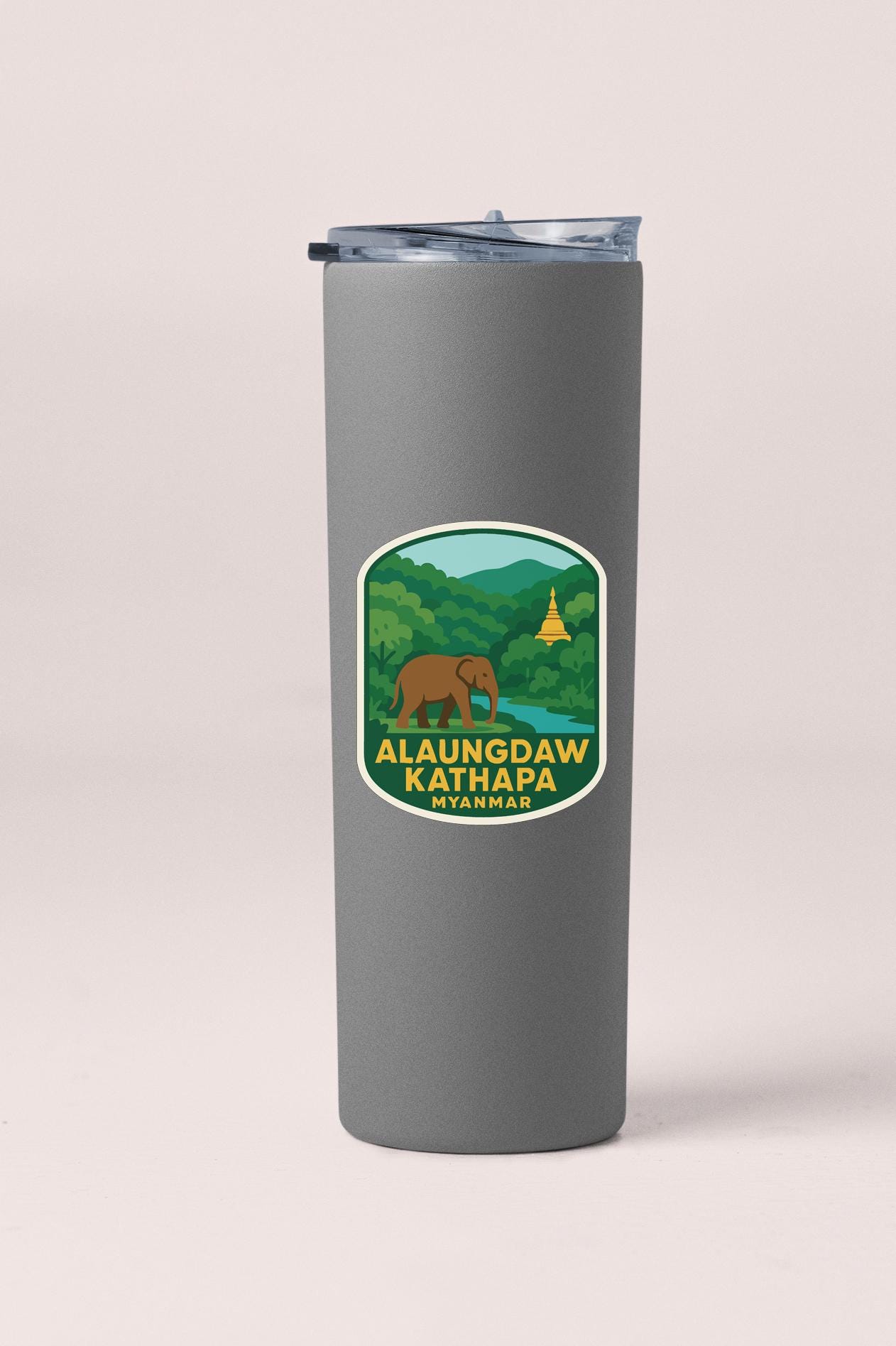 A gray tumbler with a sticker depicting a landscape and an elephant, along with the text "ALAUNDDAW KATHAPA MYANMAR".