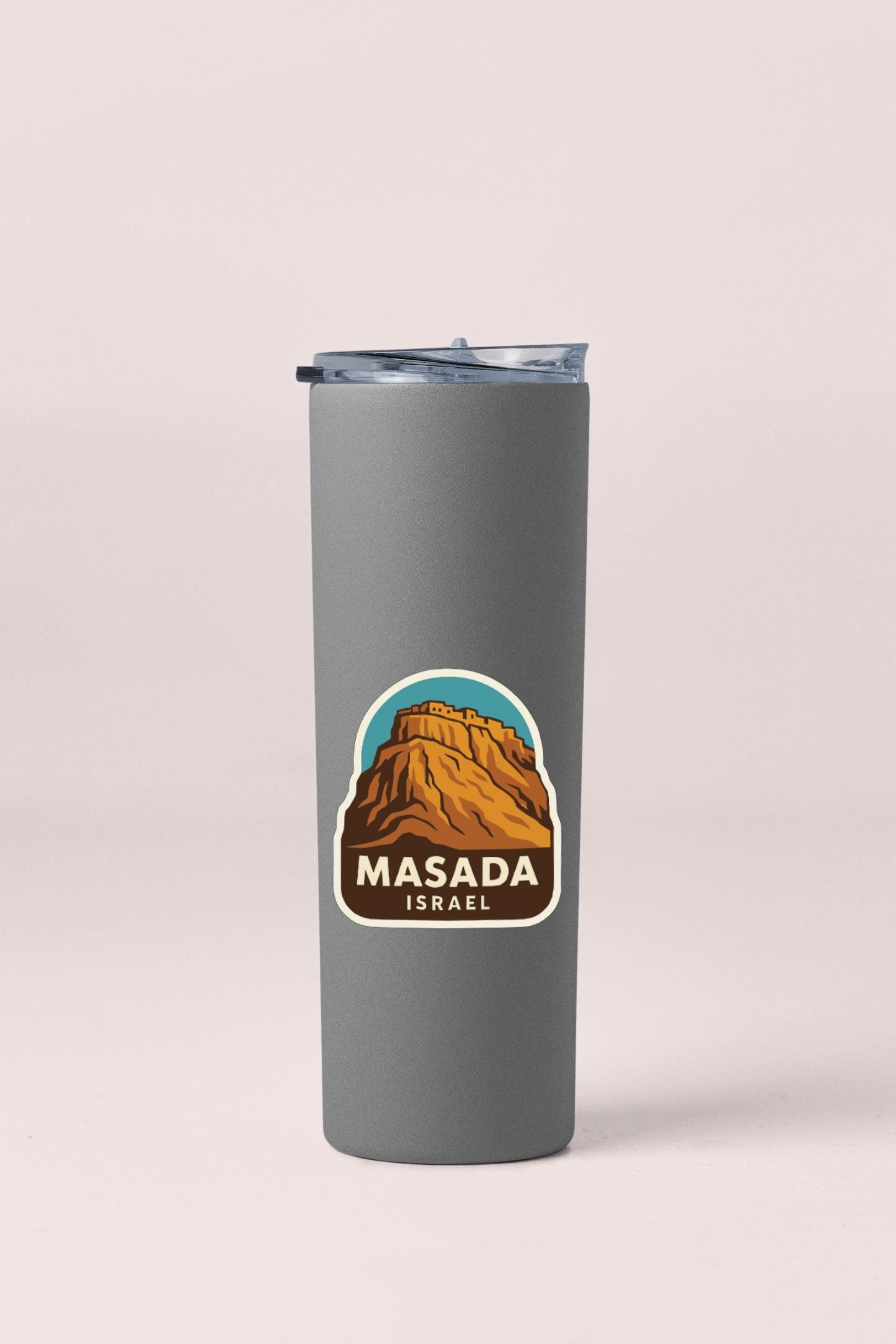 A gray insulated tumbler with a sticker depicting Masada, Israel.